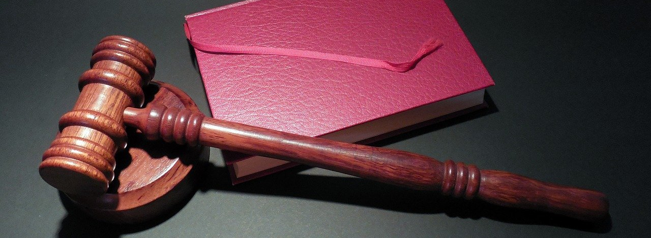 A red Bible and a judges gavel hammer