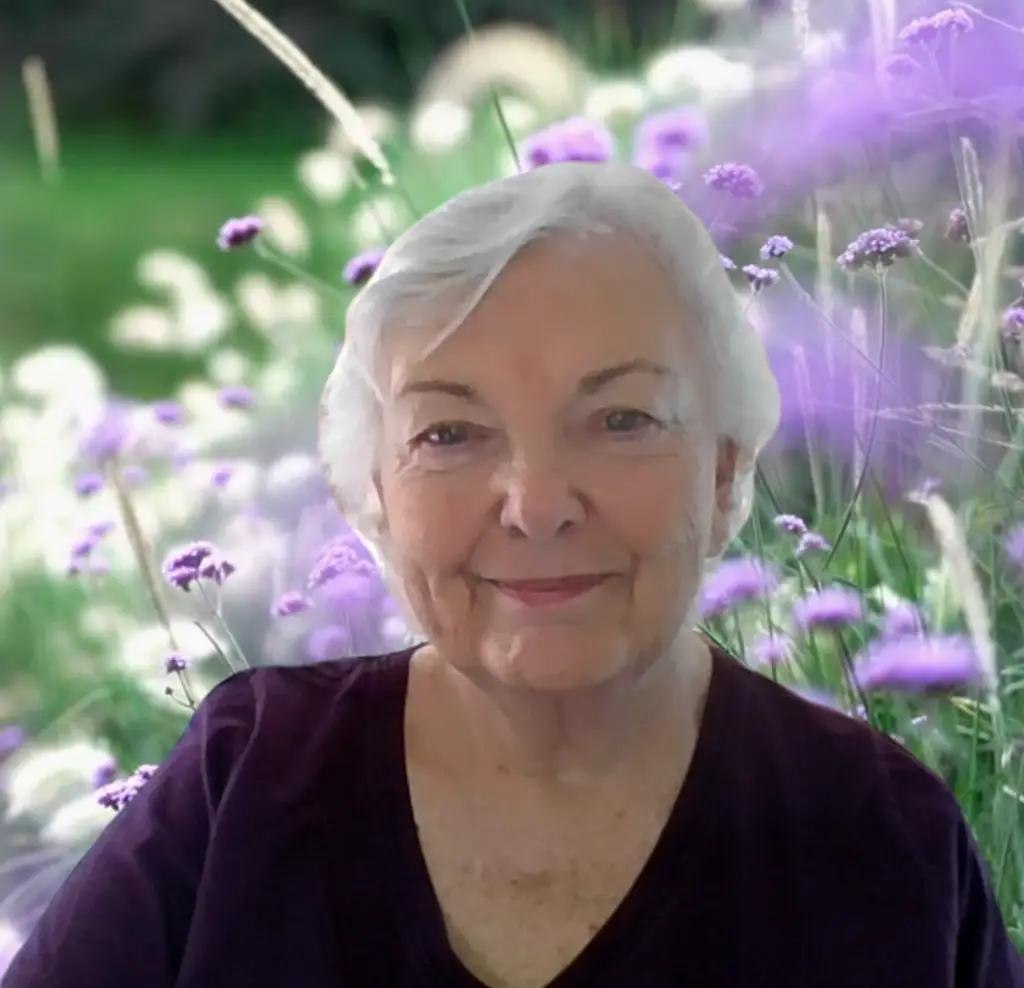 Shannon Parish photograph, with a background of lilacs from a captured Zoom screenshot